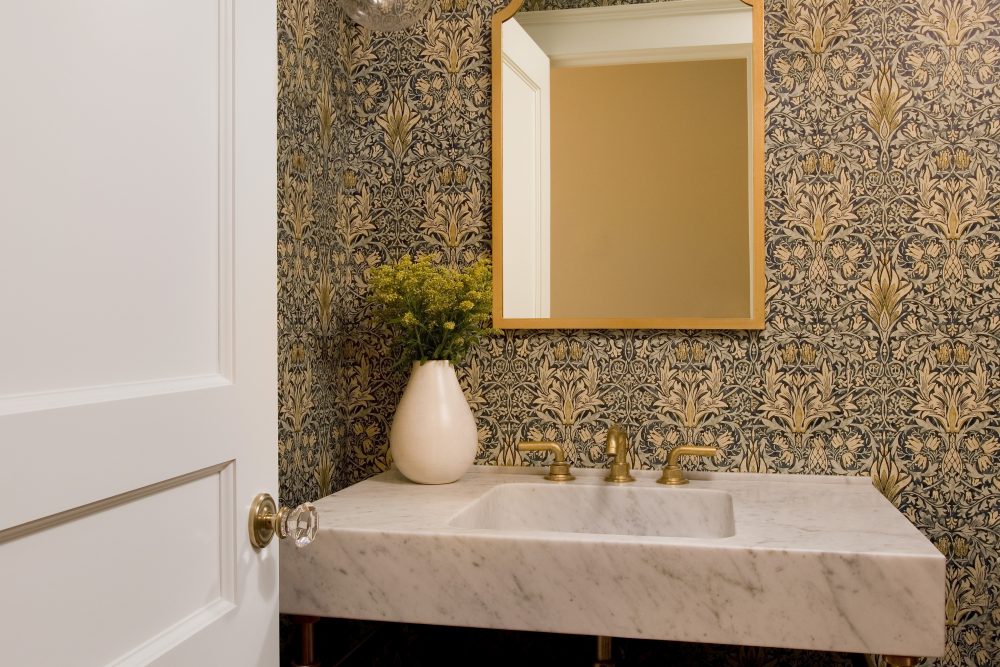 Marble bathroom sink with gold frame mirror