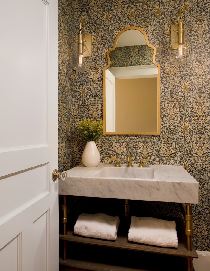 Marble bathroom sink with gold frame mirror
