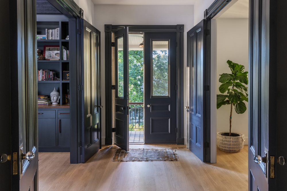 entrance way with hardwood floors and blue walls