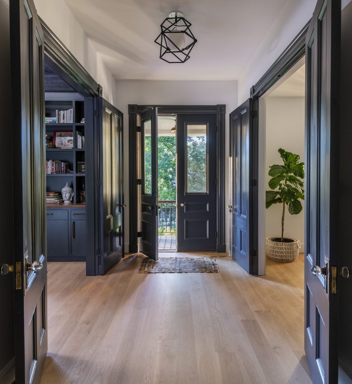 entrance way with hardwood floors and blue walls
